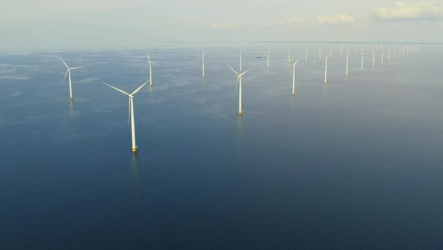 Aerial view of wind turbines in Netherlands. Working offshore wind farm. Concept: power plant, climate change, sustainable resources, global warming, renewable energy source