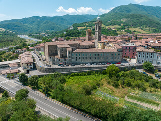 Aerial view of Bobbio, a town on the Trebbia river. Bridge. Piacenza, Emilia-Romagna. Details of the urban complex, roofs and bell towers of the town between the valleys of the Apennines. Italy
 - obrazy, fototapety, plakaty