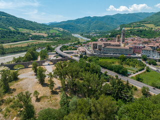 Fototapeta na wymiar Aerial view of Bobbio, a town on the Trebbia river. Bridge. Piacenza, Emilia-Romagna. Details of the urban complex, roofs and bell towers of the town between the valleys of the Apennines. Italy 