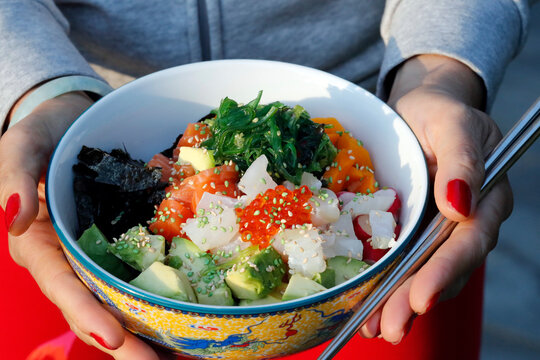 Asian cuisine, fish poke bowl with seaweed, avocado, cucumber, radish, sesame seeds, Haute-Savoie
