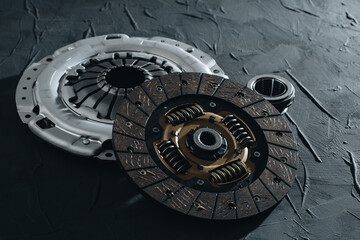 Automotive clutch mechanism, disc, basket and bearing for auto on a black background.