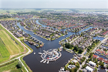 Fototapeta na wymiar Aerial top shot from houses with boats in Friesland the Netherlands