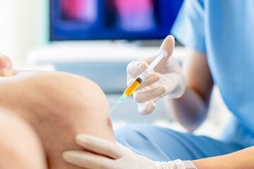 doctor make injection in knee - obrazy, fototapety, plakaty