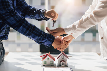 Real estate agent shake hand the signing of the agreement is complete. Contractor engineer gives...
