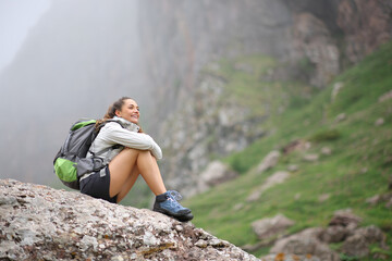 Naklejka na ściany i meble Trekker contemplating views in the mountain