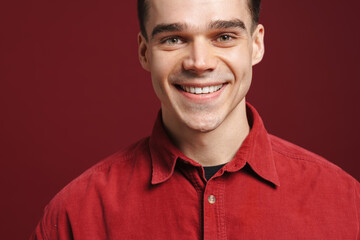 Young white man wearing shirt smiling and looking at camera