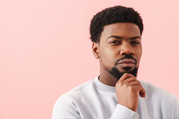 Black mid man with beard posing and looking at camera