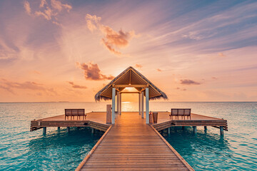 Amazing sunset landscape. Picturesque summer sunset in Maldives. Luxury resort villas seascape with soft led lights under colorful sky. Dream sunset over tropical sea, fantastic nature scenery
 - obrazy, fototapety, plakaty