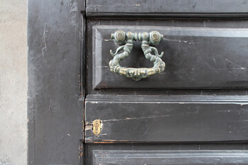 old door with knocker in catania in sicily (italy) 