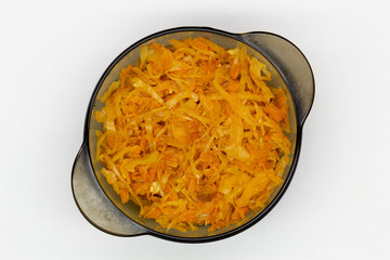 Cabbage stewed in tomato. Homemade steamed cabbage with fresh tomatoes and carrots in a black plate...