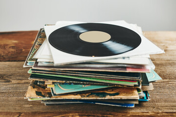 Stack of vinyl records. Listening to music from record. Playing music from analog disk. Retro and...