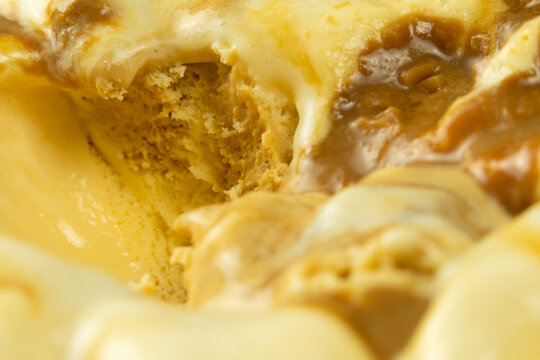 Macro photography of ice cream with caramel. A close-up view of a sweet dessert from above. Abstract food background