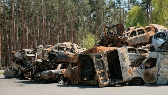 City dump of destroyed cars of civilians in Irpin, Ukraine. War in Ukraine.