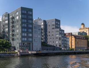 Obraz premium New and old apartment buildings at the water front in the district Nacka a sunny summer day in Stockholm 