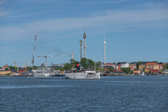 Commuter boats leaving Stockholm for the archipelago, steam ship Vaxholm lll and a modern boat a sunny summer day in Stockholm