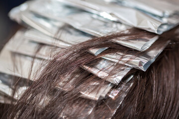 Hairdresser stylist takes care of girl's hair. Hair care procedures in a beauty salon. Hair...