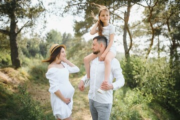 Pregnant woman with her family looking happy