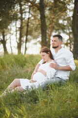 Fototapeta premium Pregnant woman with her family looking happy