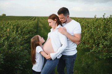 Fototapeta na wymiar Pregnant woman with her family looking happy
