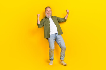 Full size portrait of delighted person raise fists celebrate success scream yeah hooray isolated on yellow color background