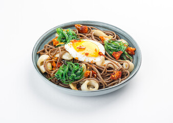 Plate with asian food - buckweet noodle with egg, mashrooms and vegetables