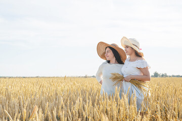 Two smiling female friends in the wheat field