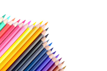 Lots of colored pencils lined upisolated on white background.
