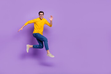 Fototapeta na wymiar Full size profile side photo of cheerful carefree man running traveling during summer holiday isolated on purple color background