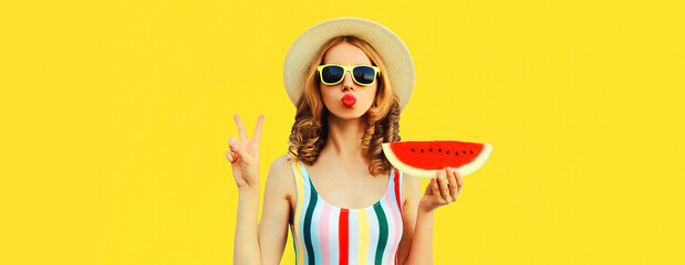 Summer portrait of young woman blowing her lips with red lipstick with fresh slice of watermelon on...