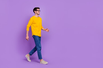 Full size profile side photo of young handsome man go on walk loo empty space isolated on violet color background