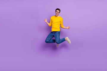 Fototapeta na wymiar Full body image of overjoyed funny man jumping in victory win money prize lottery isolated on violet color background