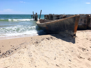 Wooden fishing boat on shore.