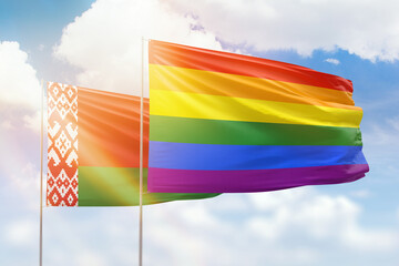 Sunny blue sky and flags of lgbt and belarus