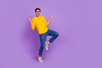 Full body image of cheerful overjoyed laughing man raise fists in victory triumph win money isolated on purple color background
