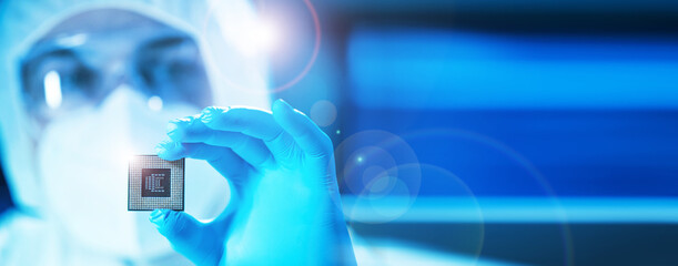 The scientist works in a modern scientific laboratory for the research and development of microelectronics and processors. Microprocessor manufacturing worker uses computer technology and equipment.