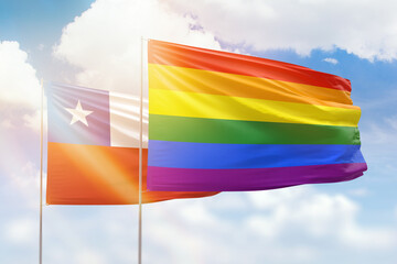 Sunny blue sky and flags of lgbt and chile