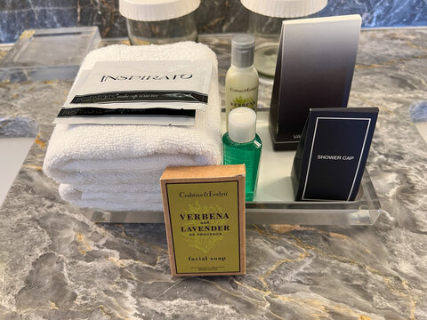 A display of hand soap, body lotion, towels and shower accessories in a hotel room bathroom at the Conrad Hilton in Ft. Lauderdale, Florida.