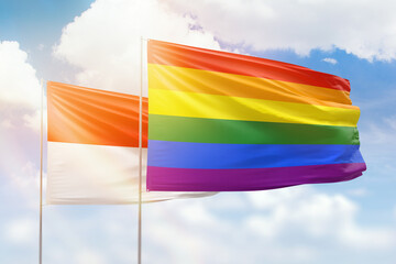 Sunny blue sky and flags of lgbt and indonesia