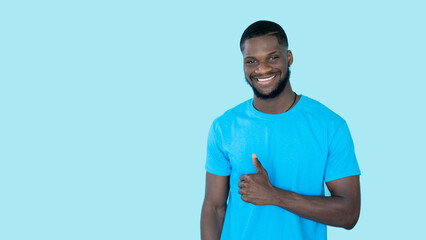 Thumbs up. Agreement sign. Offer advertising. Happy satisfied man showing like approval hand gesture on blue copy space banner background.