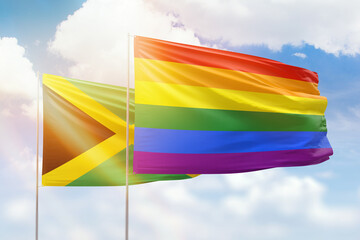 Sunny blue sky and flags of lgbt and jamaica