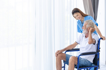 senior elderly man sitting on wheel chair with nurse care happy smile in home care hospital.