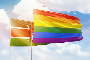 Sunny blue sky and flags of lgbt and kenya