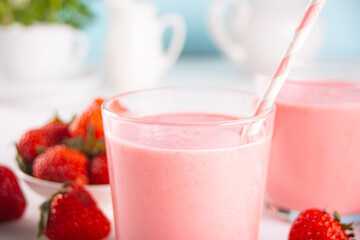 Glasses of strawberry milkshake or smoothie. Summer healthy vitamin beverage, diet or vegan food