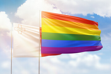 Sunny blue sky and flags of lgbt and malta