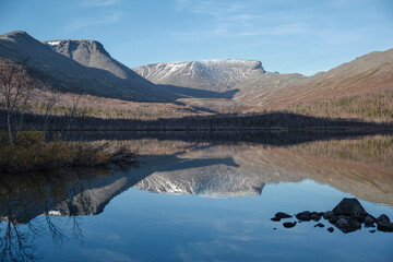 The beautiful blue lake is mountain peaks. Mountain landscape in Kola Peninsula, Arctic, tundra