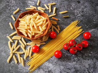 Various types of pasta, Raw pasta set and tomato, set