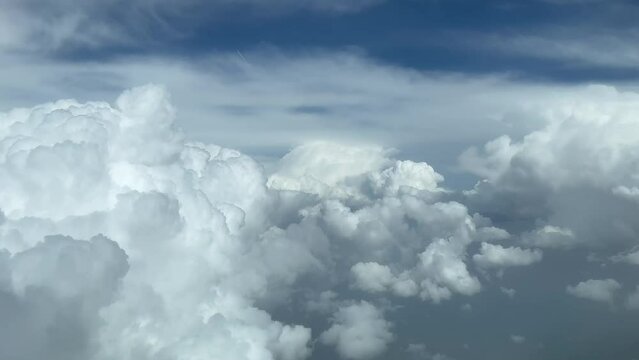 Aerial View From A Jet Cockpit, Pilot POV While Flying Through A Stormy And Messy Sky With A Deep Blue Sky.4k