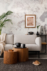 The stylish compostion at living room interior with design gray sofa, woooden coffee table, poster...