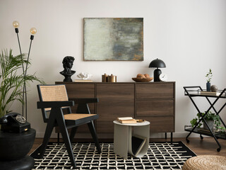 The stylish compostion at living room interior with mock up, wooden commode, rattan chairs and...