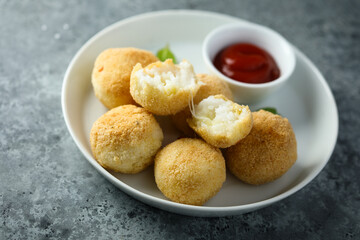 Traditional homemade arancini balls with tomato sauce	